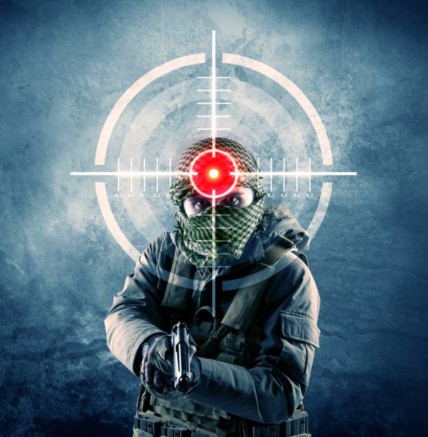 Masked terrorist man with gun and laser target on his body concept