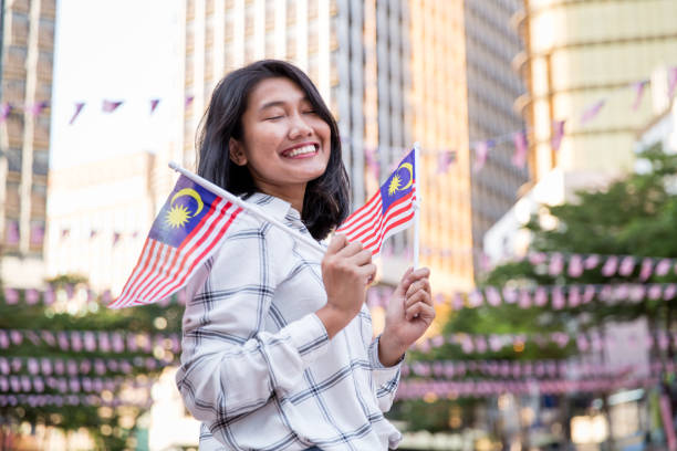 istock One girl holding Malaysian Flag 1019995490