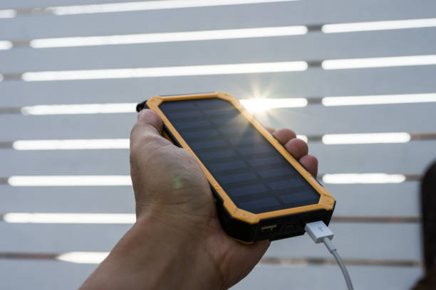istock Yellow Solar Cell Smartphone Charger Laydown on Wooden table 1019996256