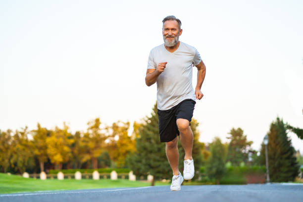 istock The happy elderly man running on the road 1019998660