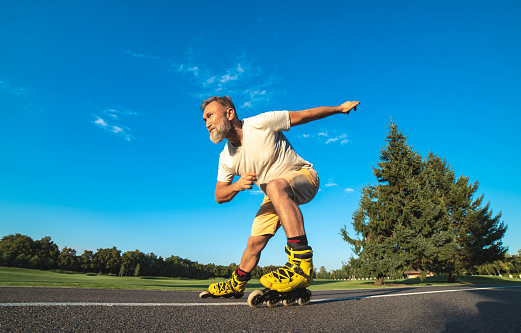 He Old Man Rollerblading On The Road Stock Photo - Download Image Now ...