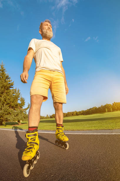 istock The old man in rollers standing on the road 1020000832