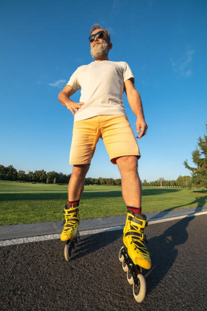 istock The old man with rollers standing on the asphalt 1020000876