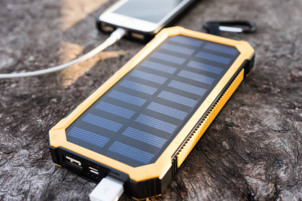 istock Yellow Solar Cell Smartphone Charger Laydown on Wooden table 1020001052