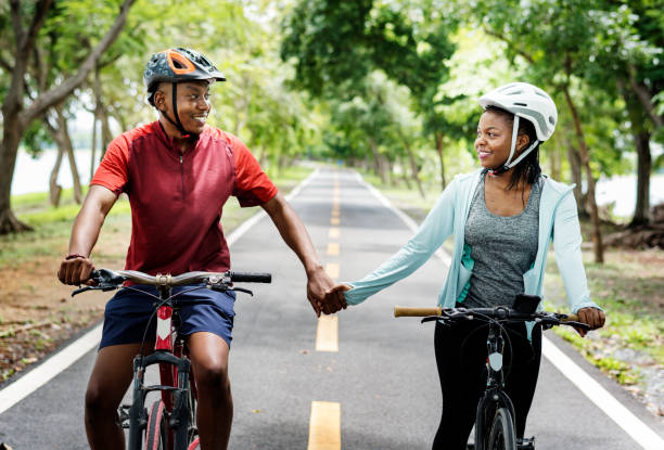 istock Cyclist couple riding bikes in a park 1020005680