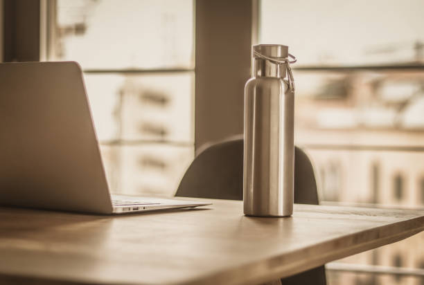 Modern Workplace - minimalist lifestyle, water bottle Modern Workplace - minimalist lifestyle, stainless steel water bottle bottled water on table stock pictures, royalty-free photos & images