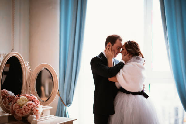 istock young bride and groom couple in a bright studio photo 1020010474
