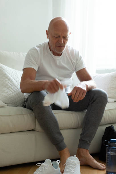 istock Senior man relaxing at home after workout 1020023312