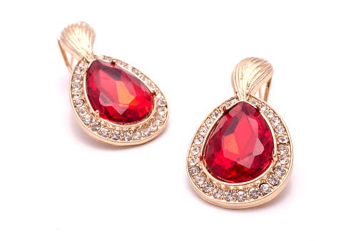 gold earrings with ruby drops isolated on white