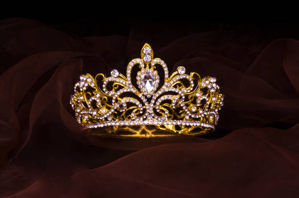 istock gold crown with diamonds isolated on the fabric 1020025976