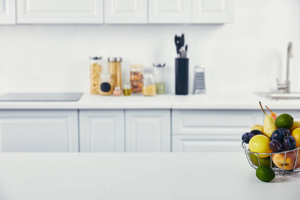 istock close up view of white table with fresh fruits in kitchen 1020029456