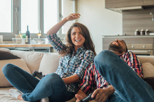 istock Young couple playing video games and laughing 1020031562