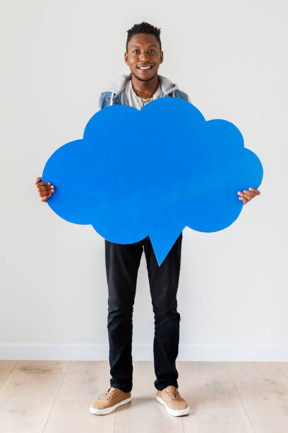Happy African American man holding copyspace speech bubble