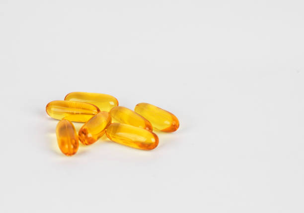 istock Fish oil supplement capsules source of omega3 selective focus in front object isolated on white background. 1020033244