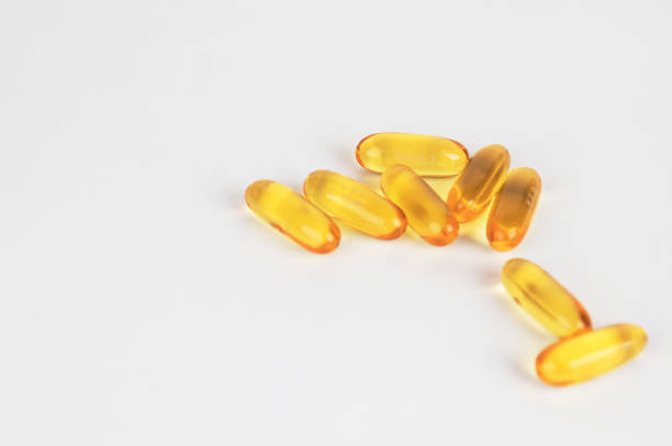 istock Fish oil supplement capsules source of omega3 selective focus in front object isolated on white background. 1020033326