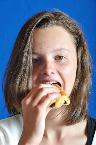 istock A  teen eating a chocolat bun 1020037448