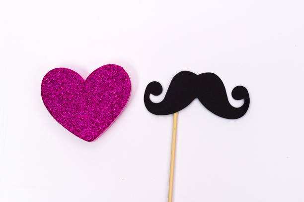 istock paper mustache on a stick and a pink heart on white background 1020040746