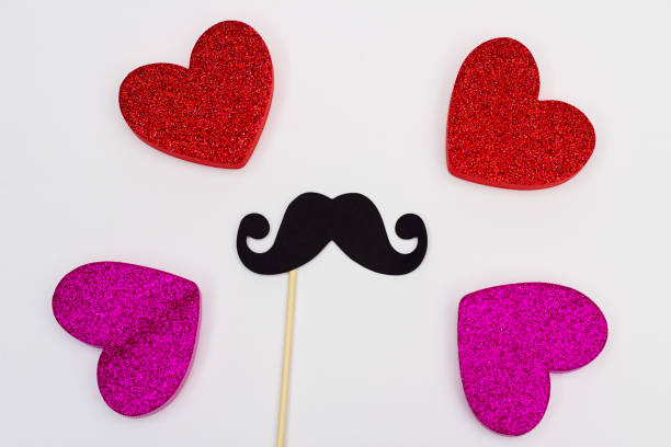 istock Photo booth props Black Mustache against blurred hearts on white background 1020040910