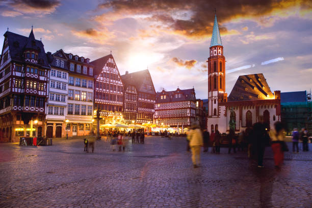 People in Frankfurt old town square at dusk