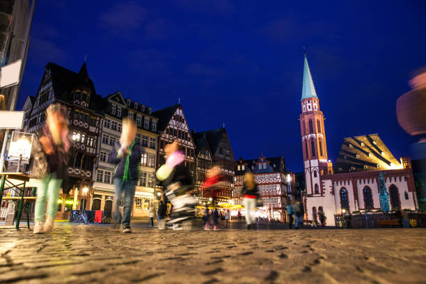 istock People in Frankfurt old town square at dusk 1020049232