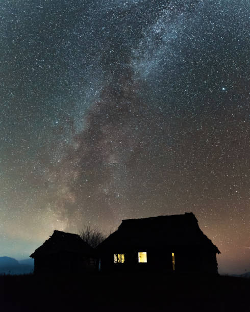 Landscape with alone old house on foggy meadow. Can be used like Halloween background. Located place: Carpathians, Europe