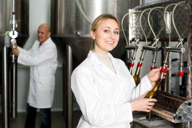 istock Smiling female brewery worker with bottling machinery 1020054490