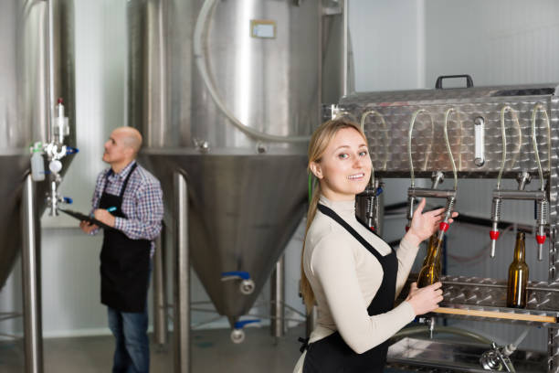 istock Woman using bottling equipment on brewery 1020054520
