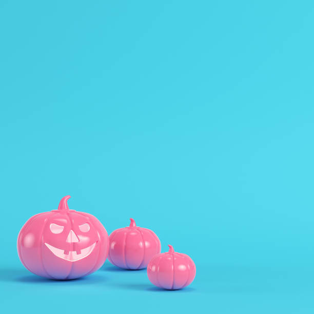 istock Pink halloween pumpkin, jack o lantern on bright blue background in pastel colors 1020063280