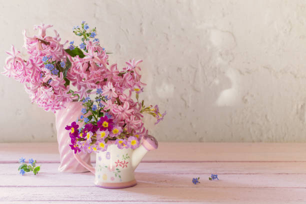 istock spring flowers in vases on wooden table 1020063318