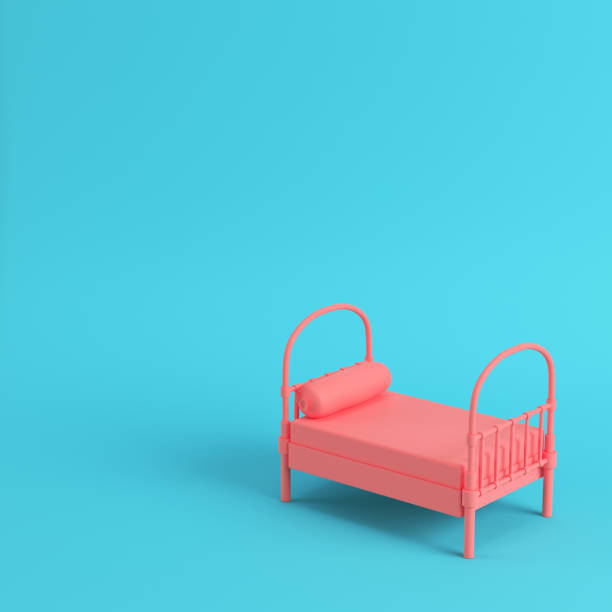 istock Pink single bed with pillow on bright blue background in pastel colors 1020063656
