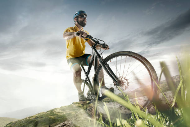 istock The young fit men in helmet conquering mountains on a bicycle 1020064310