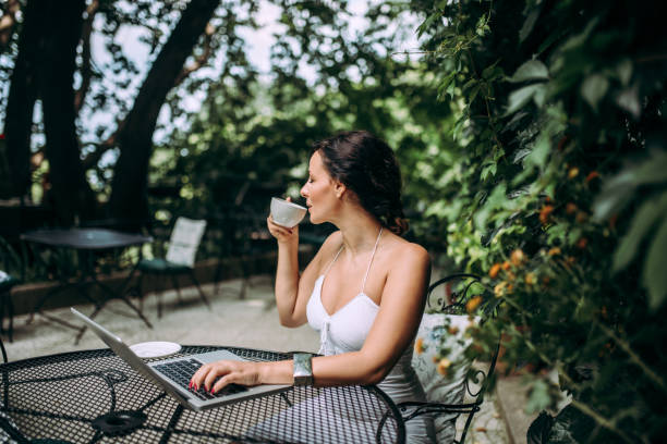 istock Young woman enjoying coffee in outdoors cafe. 1020064396