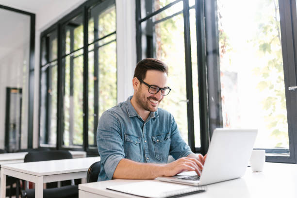 istock Portrait of happy young freelancer using laptop. 1020064588