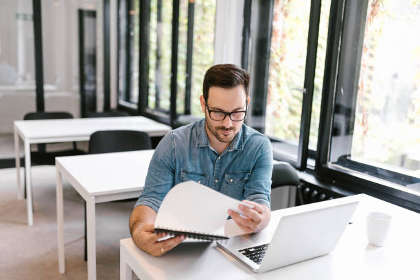 istock Portrait of a handsome young man doing research, looking at some documents. 1020064638