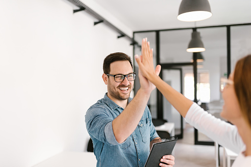 Two colleagues high-five.