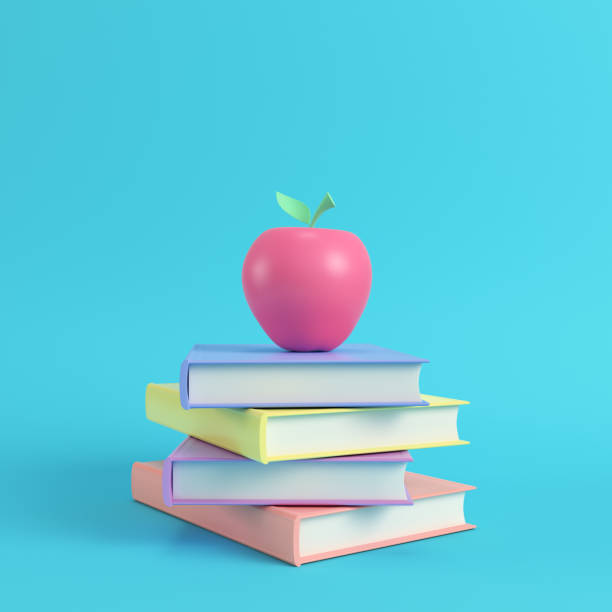 istock Pink apple on a stack of books on bright blue background in pastel colors 1020066998