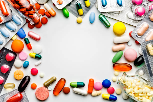 istock Large group of assorted capsules, pills and blisters making a frame on white background 1020067048