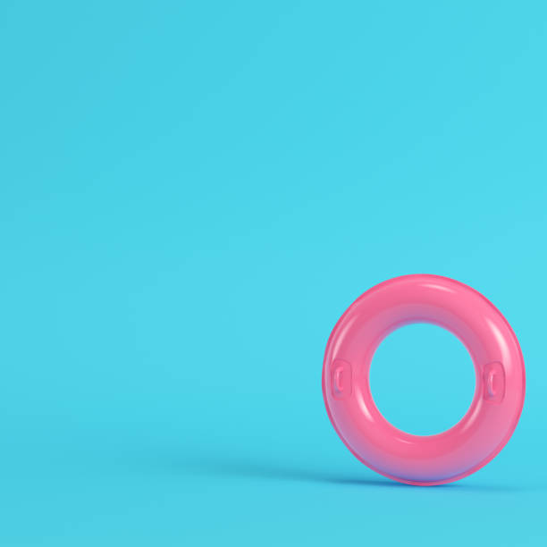 istock Pink inflatable ring on bright blue background in pastel colors 1020067320