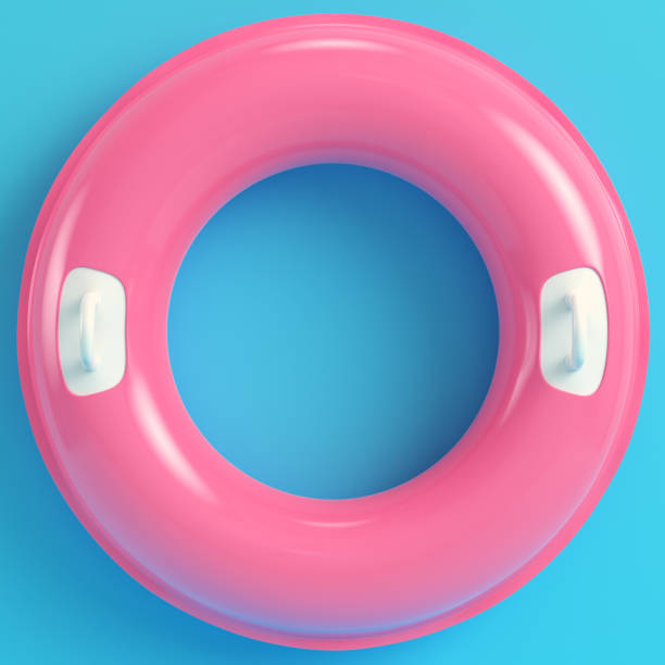 Pink inflatable ring on bright blue background in pastel colors stock photo