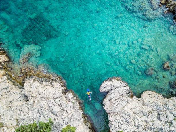 istock Aerial view of young man on the surf board 1020076346