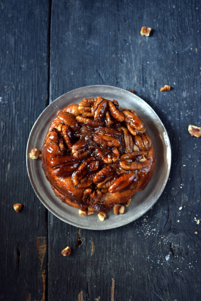 Pecan sweet roll pastry on rustic table flay lay