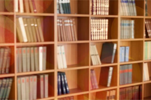 Law. Many books on shelves, Blurred Library backdrop law library stock pictures, royalty-free photos & images