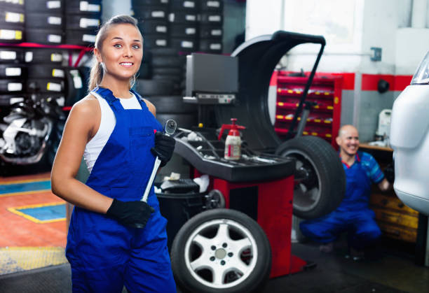istock Mechanic woman working on new tire fitting in service point 1020083078