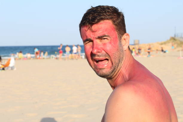 Childish looking adult crying at the beach.