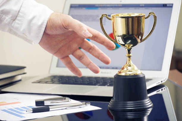 istock Businessman 's hand  grab the trophies, win concept. 1020088986