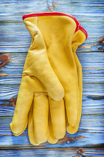 istock Leather protective gloves on vintage wooden board 1020089308