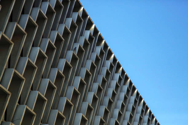 istock Building facade with windows repetition, side view with blue sky behind, repetition shape conceptual art 1020089406
