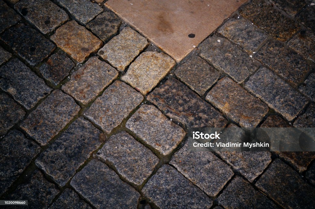 ancient cobblestone pavement Ancient stone granite pavement with a stone of different colors Ancient Stock Photo