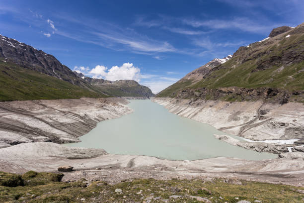 The Grande Dixence lake, formed by a dam, in the Swiss alps in Canton Valais on a sunny summer day The Grande Dixence lake, formed by a dam, in the Swiss alps in Canton Valais on a sunny summer day grand dixence stock pictures, royalty-free photos & images