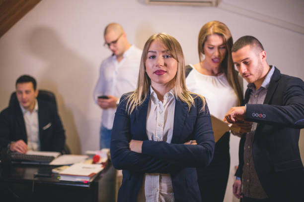 istock Content businesswoman posing while her colleagues are working in office 1020119720